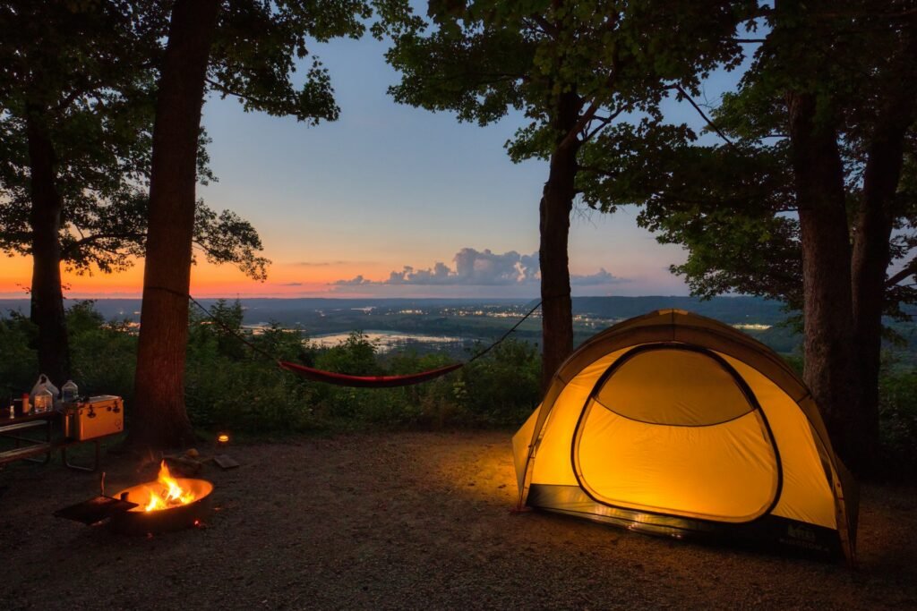 Tent set up in the woods at sunset