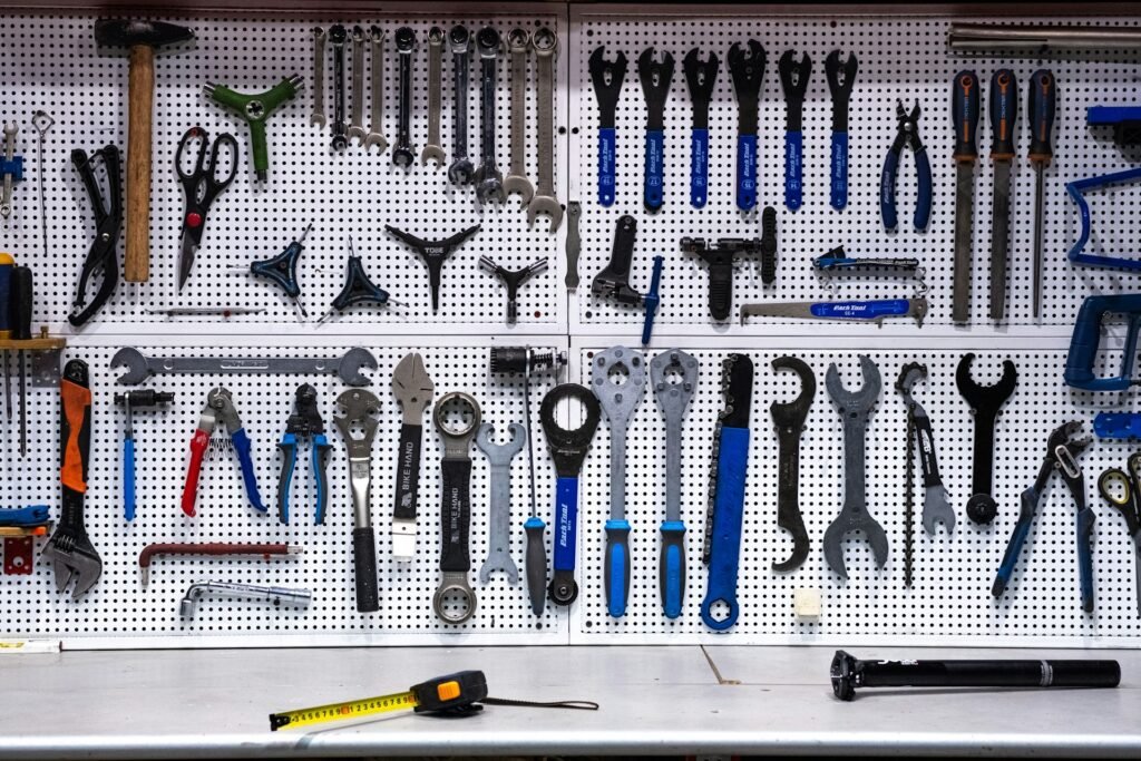 Tools organized on a white pegboard above a workbench.