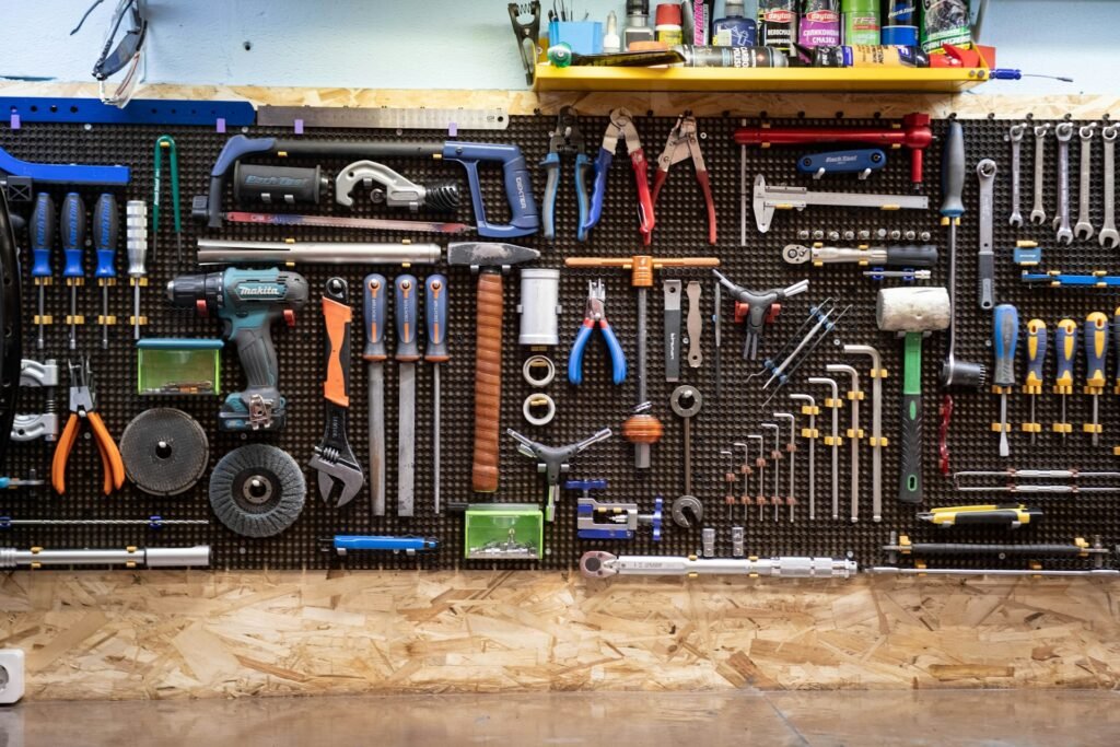 Green tools hanging on a workshop wall