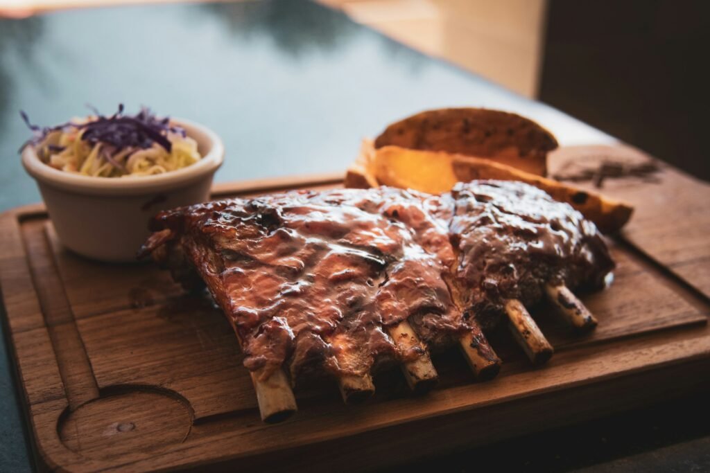 Rack of barbecue ribs on a wooden board.
