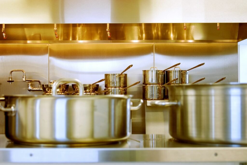 Stainless steel pots and pans on a commercial-style range.