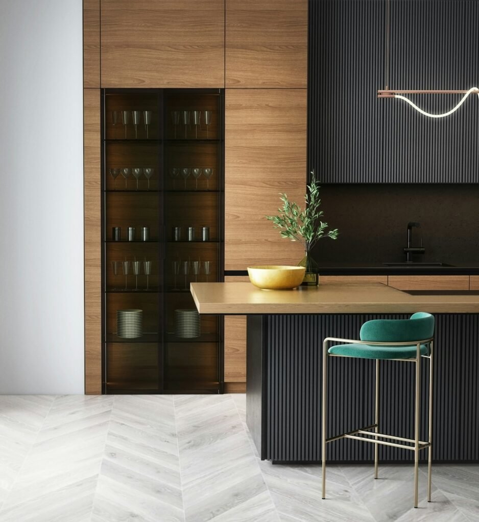 Modern kitchen with wood cabinetry, glass cabinet and a teal stool