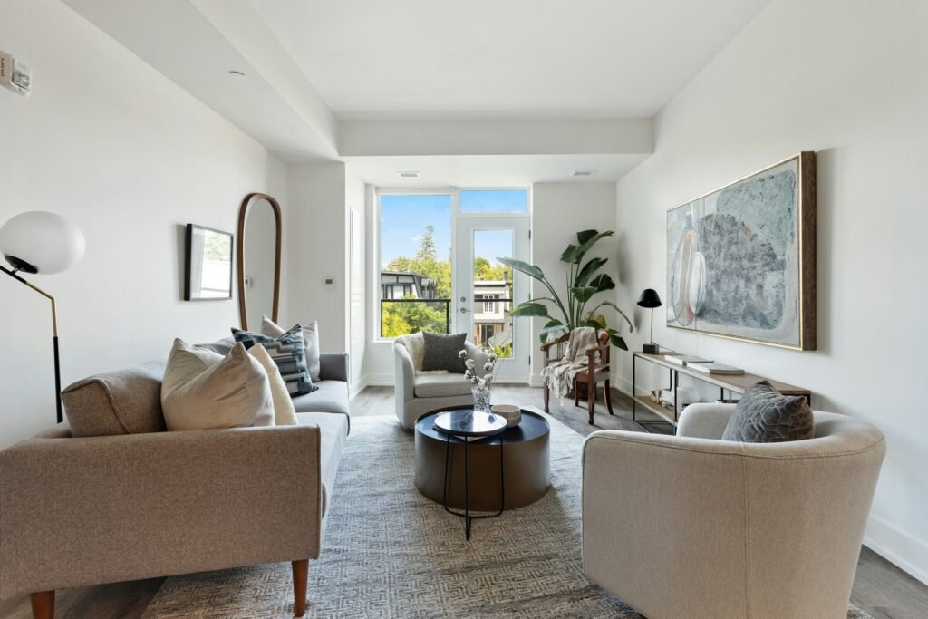 Bright living room with a white sofa and houseplants.
