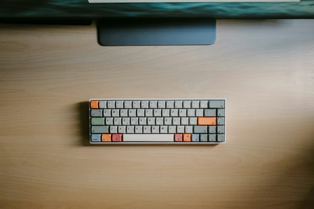 Compact keyboard on a wooden desk.