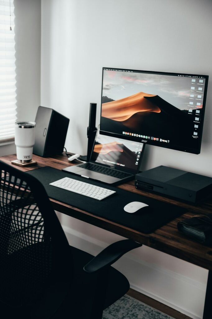 Home office desk with monitor and laptop