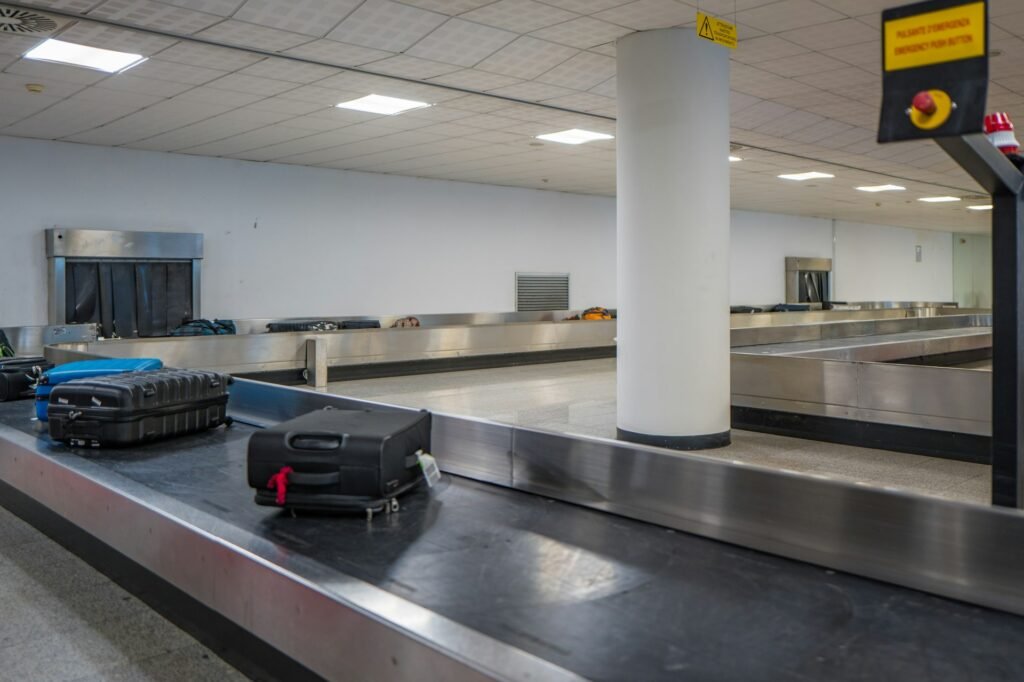 Empty airport baggage claim with a luggage carousel.