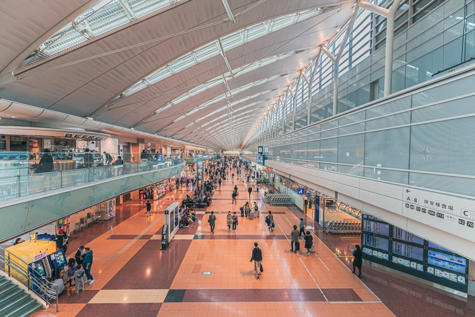 Travelers walking through a bright airport terminal