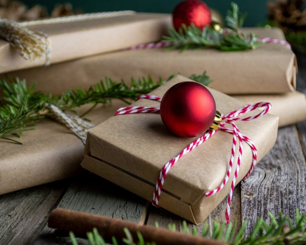 Red bauble on a brown paper wrapped gift box